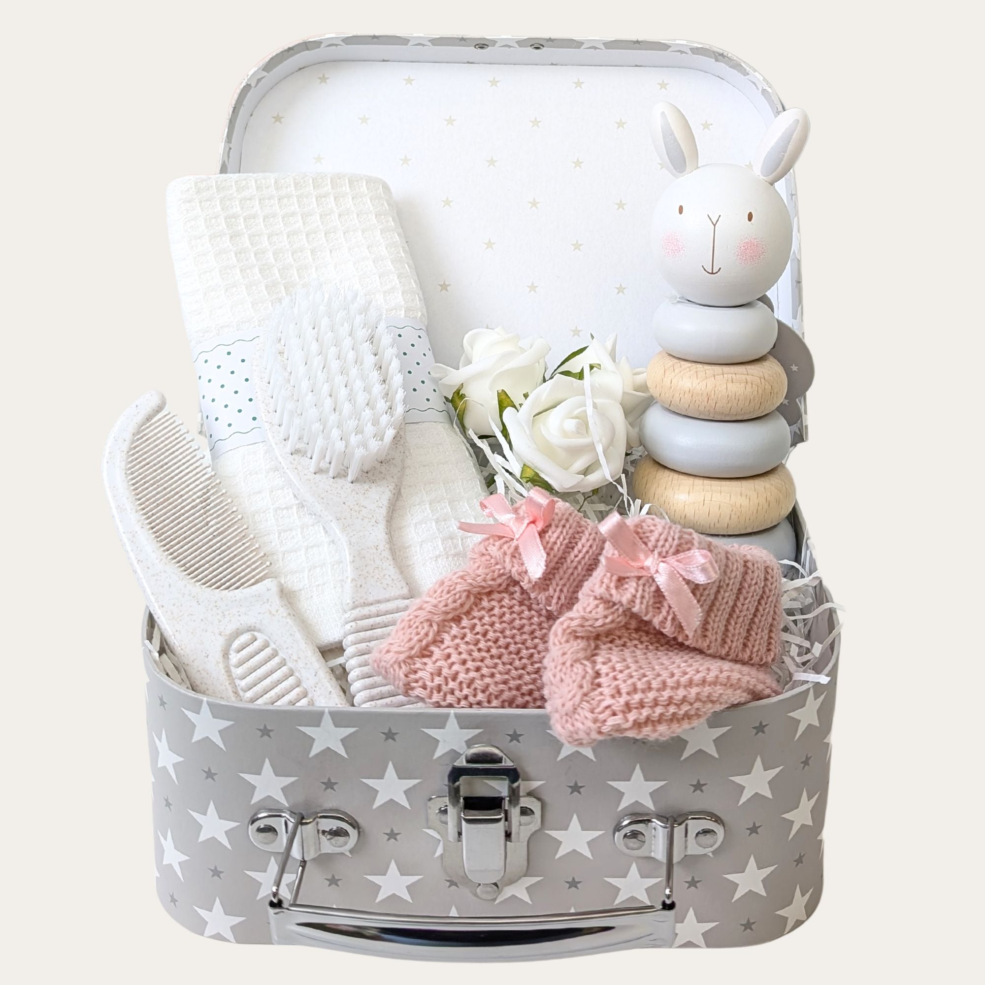 Small baby girl hamper by Bumbles and Boo with pink & white gifts and wooden toy.