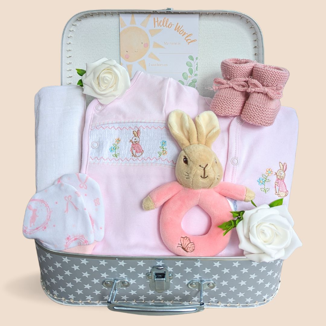 Stunning new baby girl gift hamper. Beautiful and soft Flopsy Bunny clothing set with matching hand rattle and muslin wrap to the theme of Beatrix Potter.