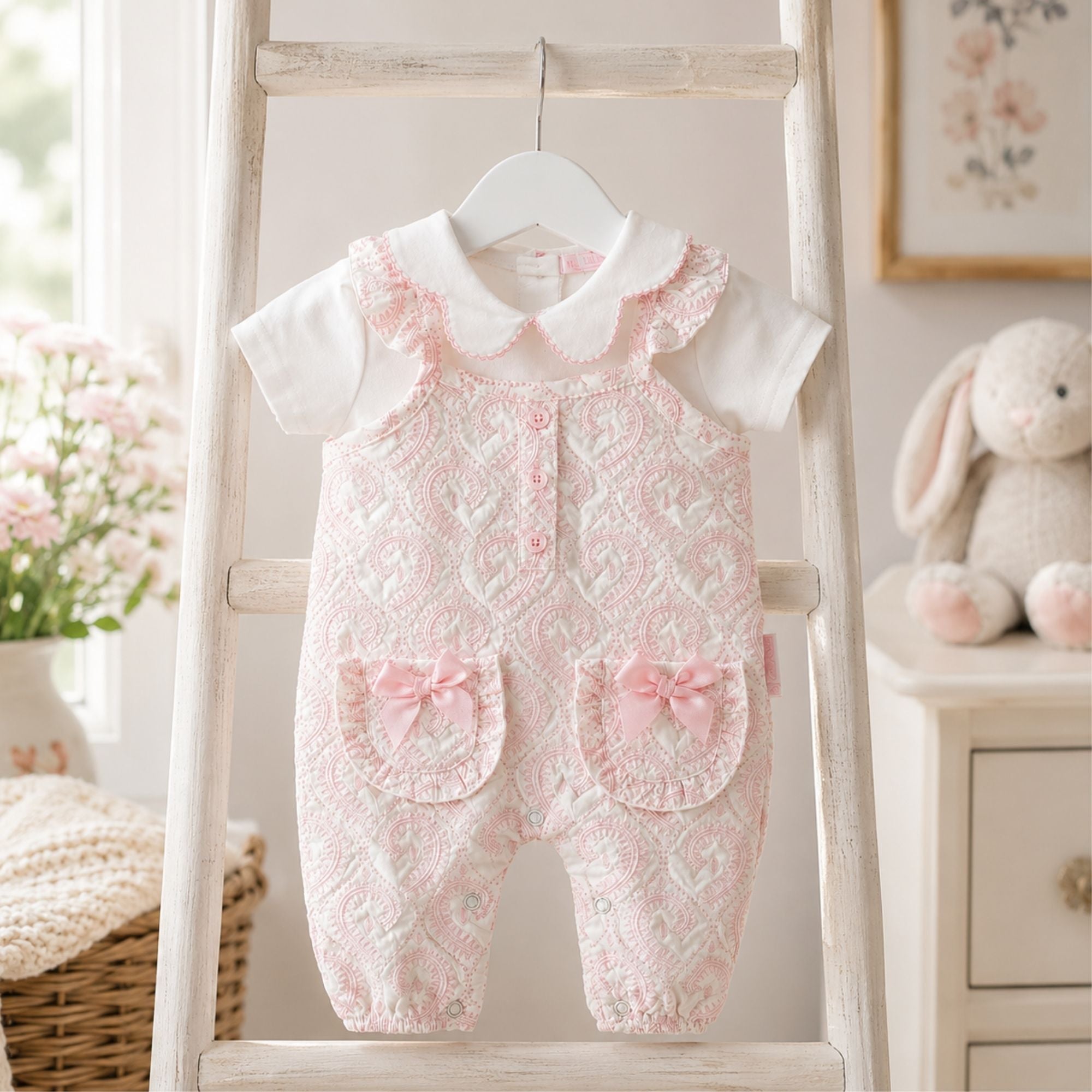 Set of baby rompers and a shirt with floral pattern on a baby