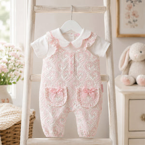 Set of baby rompers and a shirt with floral pattern on a baby