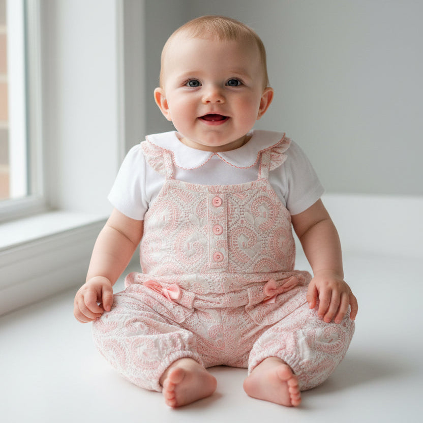 Set of baby rompers and a shirt with floral pattern on a baby