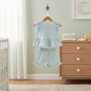 Baby girls woven blouse and shorts set in soft blue with floral print shorts. Two piece baby clothes outfit displayed flat on white background.