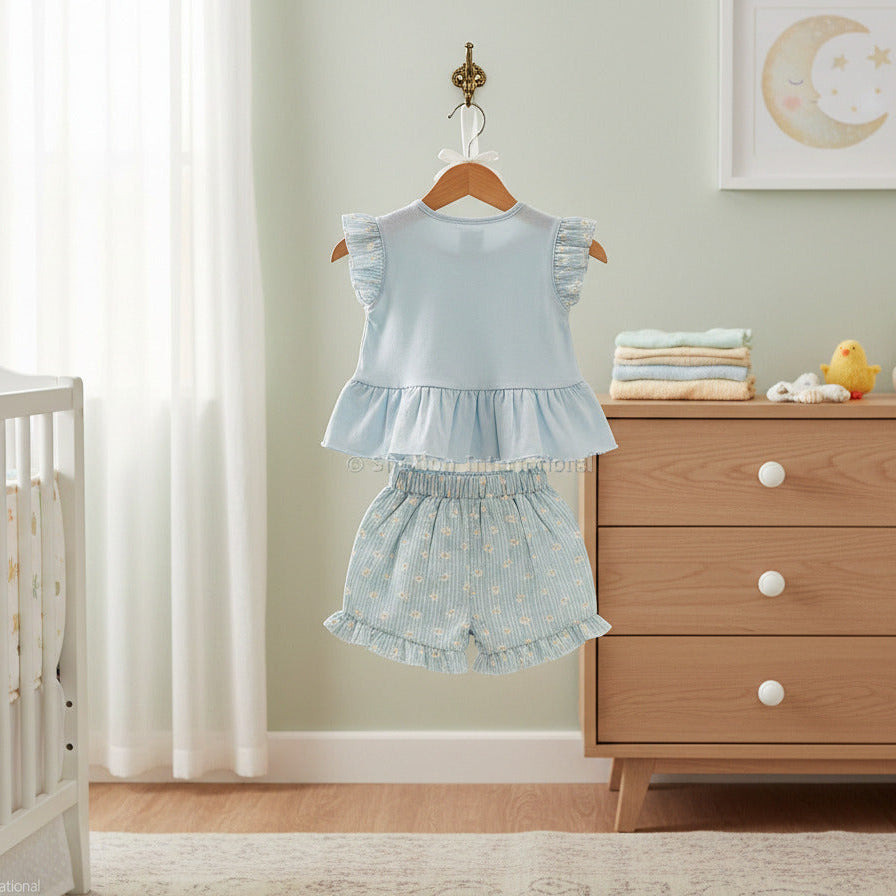 Baby girls woven blouse and shorts set in soft blue with floral print shorts. Two piece baby clothes outfit displayed flat on white background.