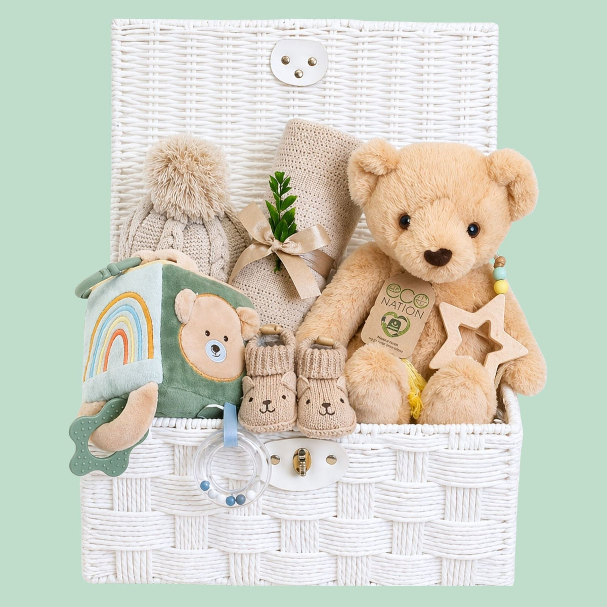 Newborn baby gifts hamper with teddy bear and soft blanket in a white basket