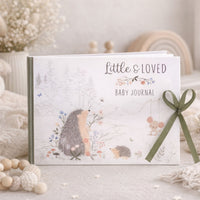 Baby journal with hedgehog illustrations and a green ribbon