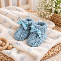 make these baby booties look better for my ecomerce website. in a lifestyle background