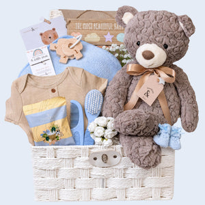 Baby shower hamper gifts with a large teddy bear and fudge for the mum to be to enjoy