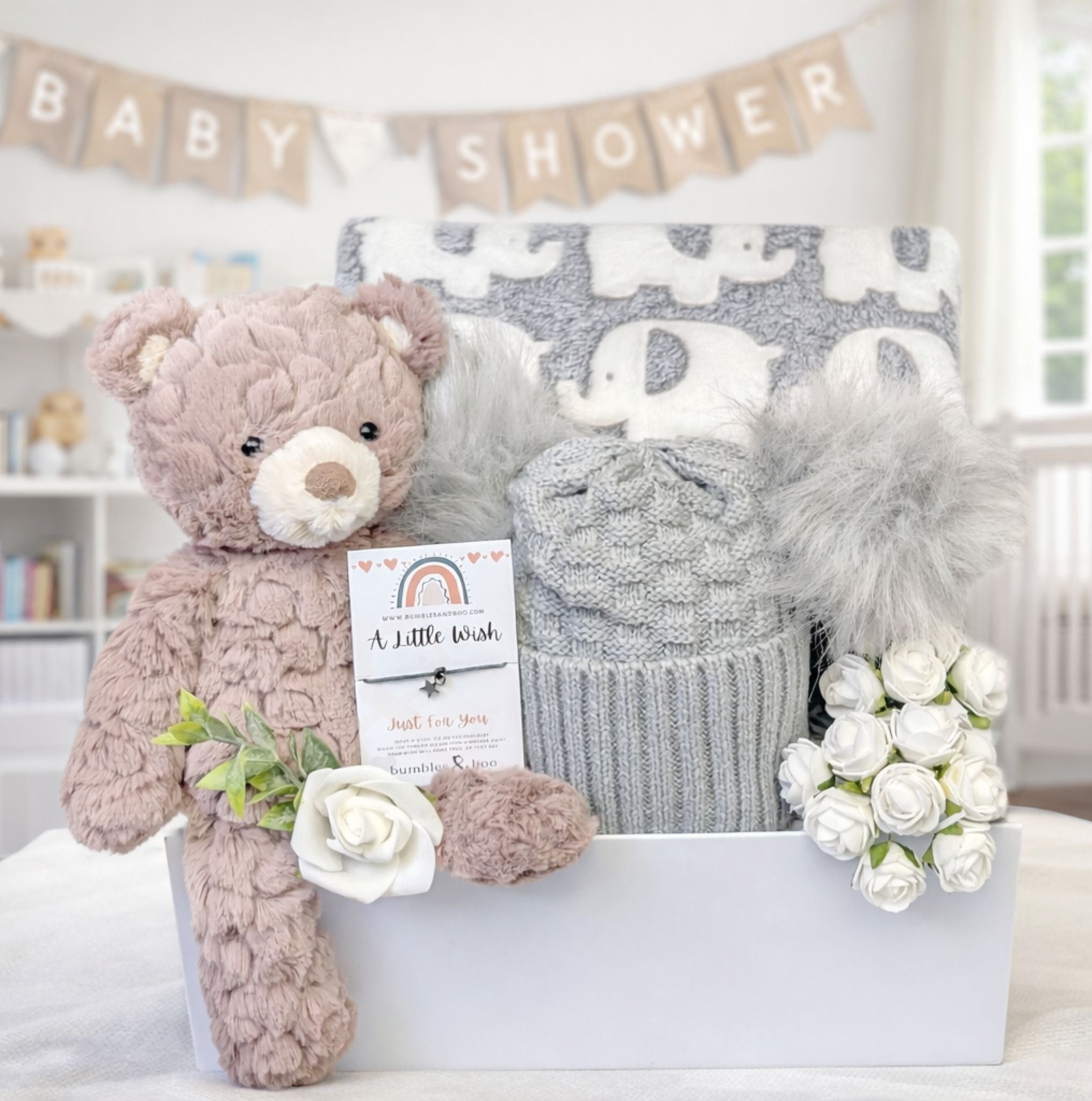 Baby shower gifts box with teddy bear, grey pompom hat and elephant blanket. Hamper design by Bumbles and Boo.
