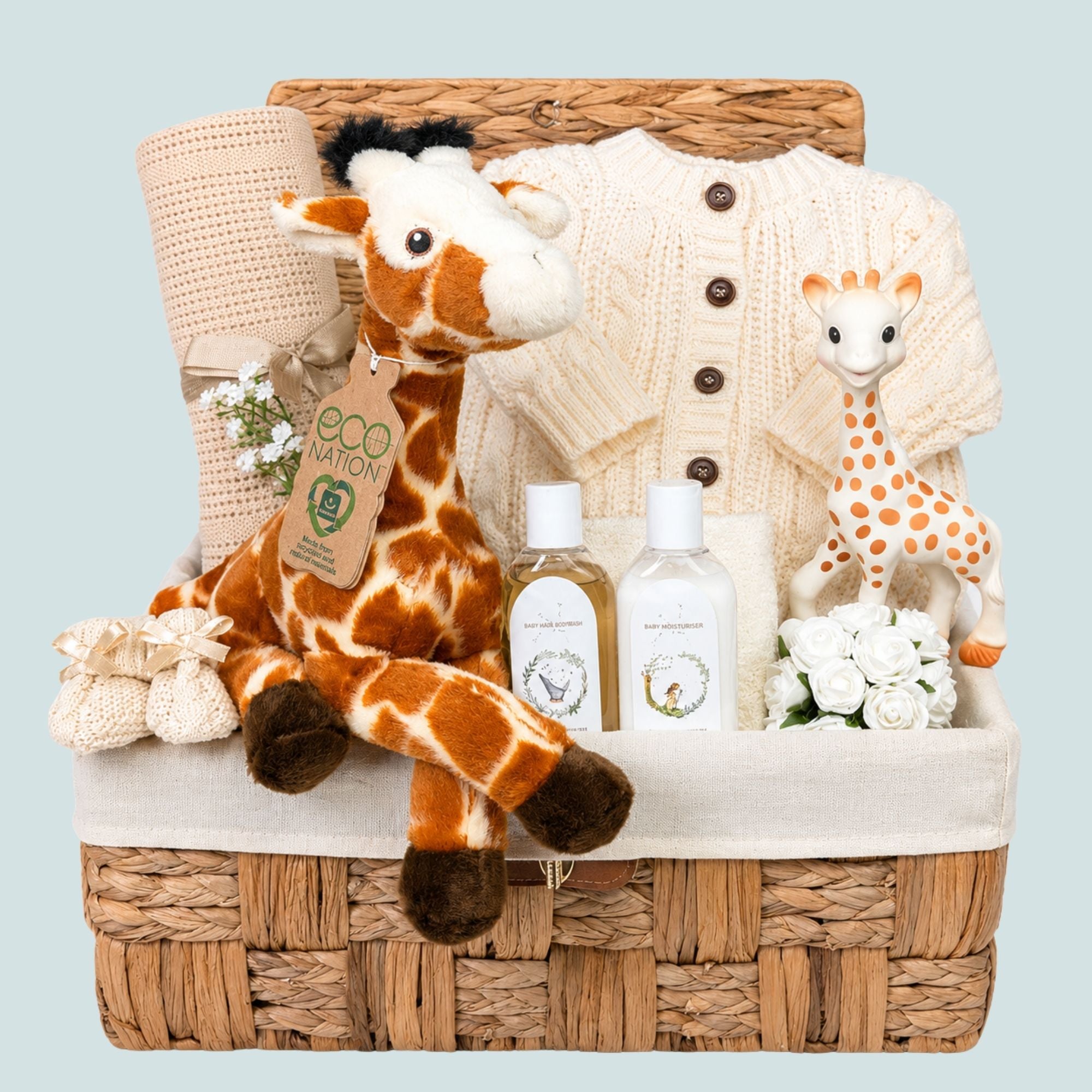 Baby shower gifts hamper basket with giraffe soft toy, and cream knit cardigan. Bumbles and Boo.