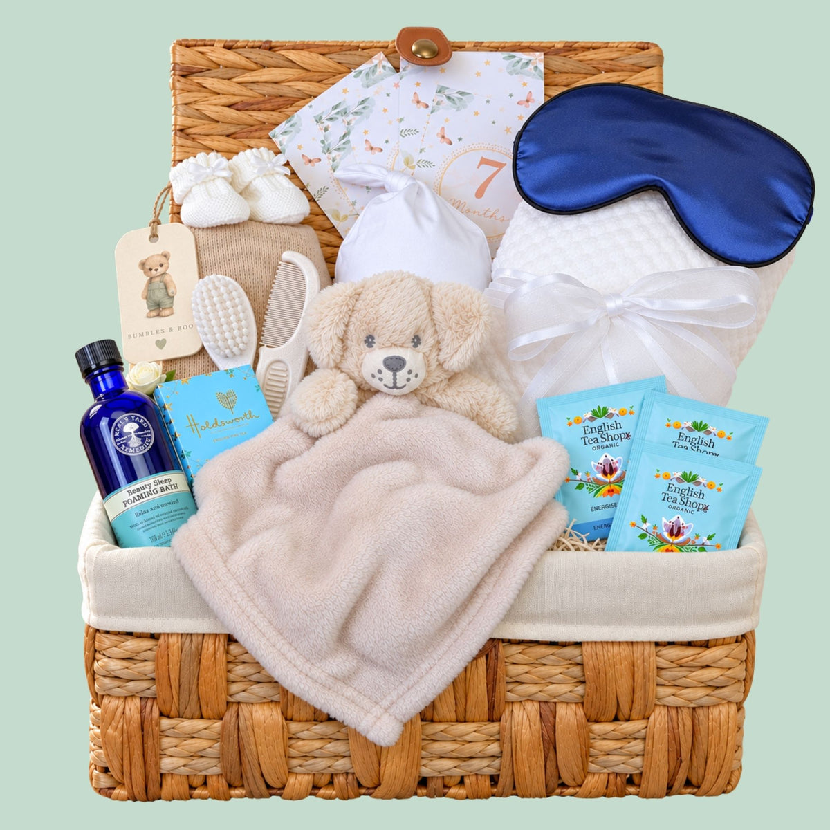 Baby shower hamper basket with Neal’s Yard gifts for mum and baby. By Bumbles and Boo.