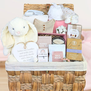 Baby shower hamper basket with lots of gifts for mum and baby in neutral unisex colours