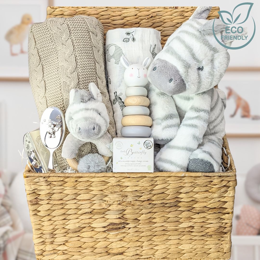 baby shower gifts with baby blanket, muslin, zebra soft toy and rattle.