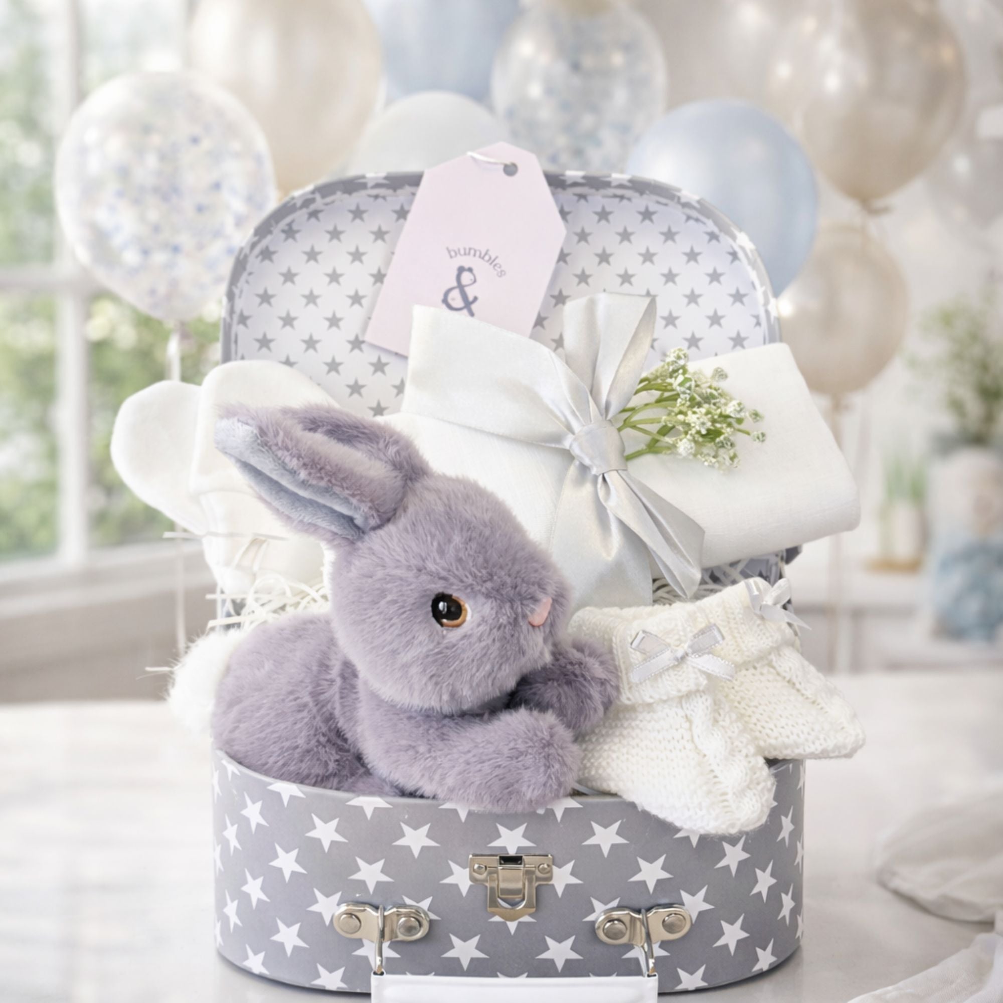 Baby shower gifts for mum in a little hamper with bunny and baby essentials