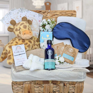 Giraffe themed baby shower basket with presents including chocolate.