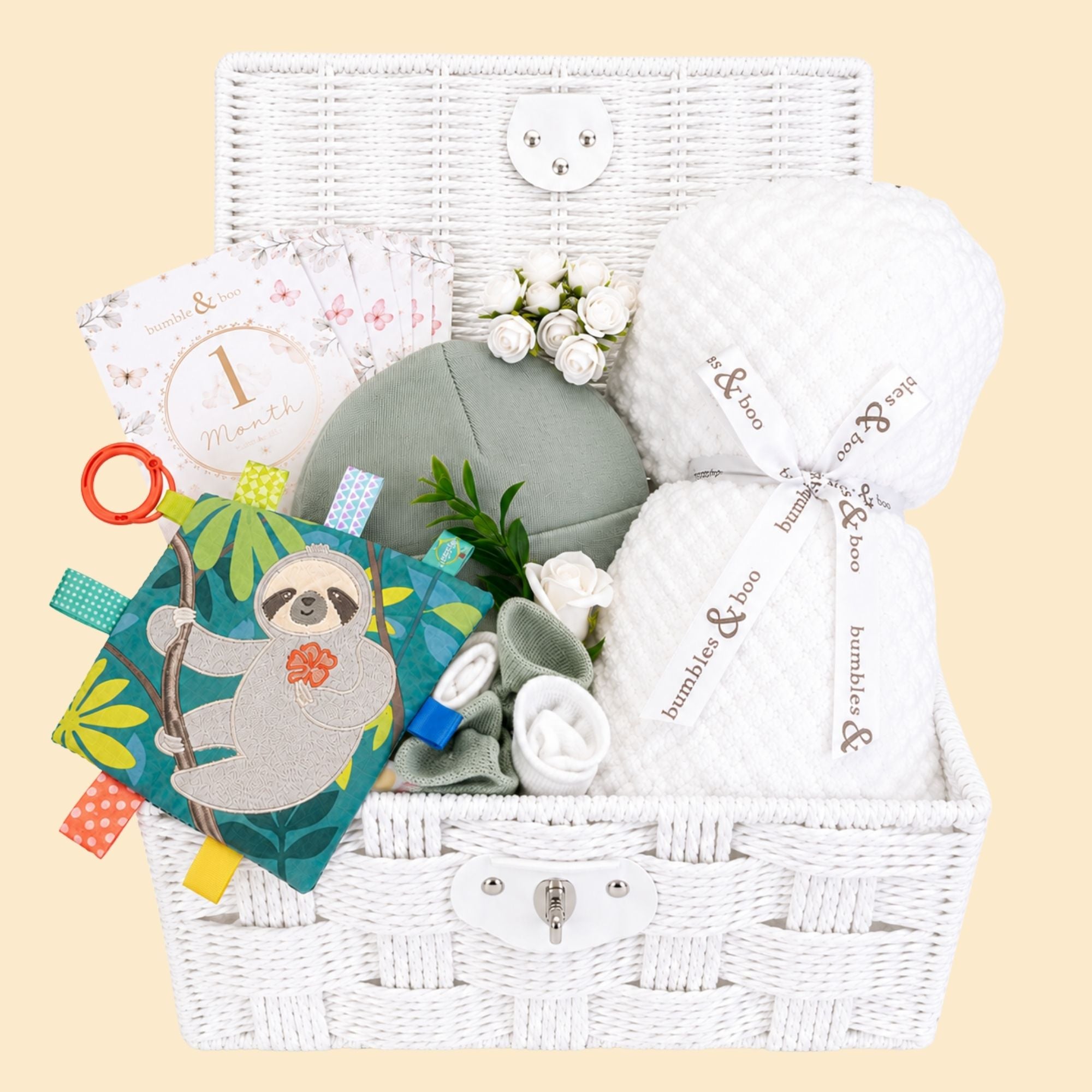 Baby shower gifts hamper with white blanket and lamb soft toy packed in a basket by Bumbles & Boo.