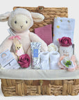 Baby shower hamper with gifts including white lamb toy & pink soap roses.