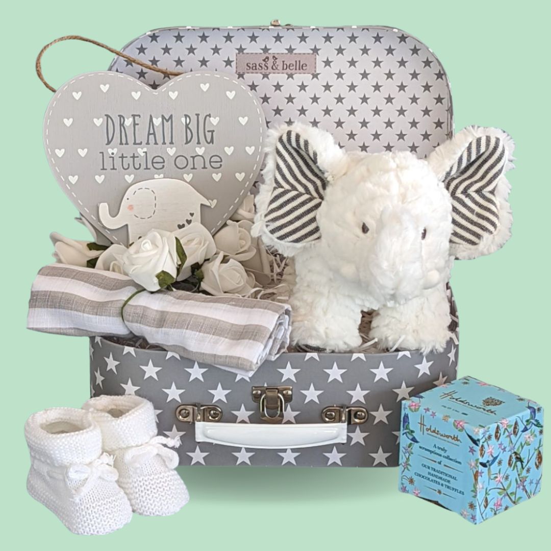 Baby shower gifts hamper with white elephant toy.