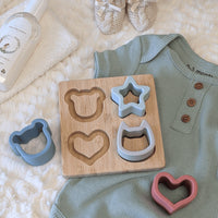 Wooden toy with shape molds for a teething baby.