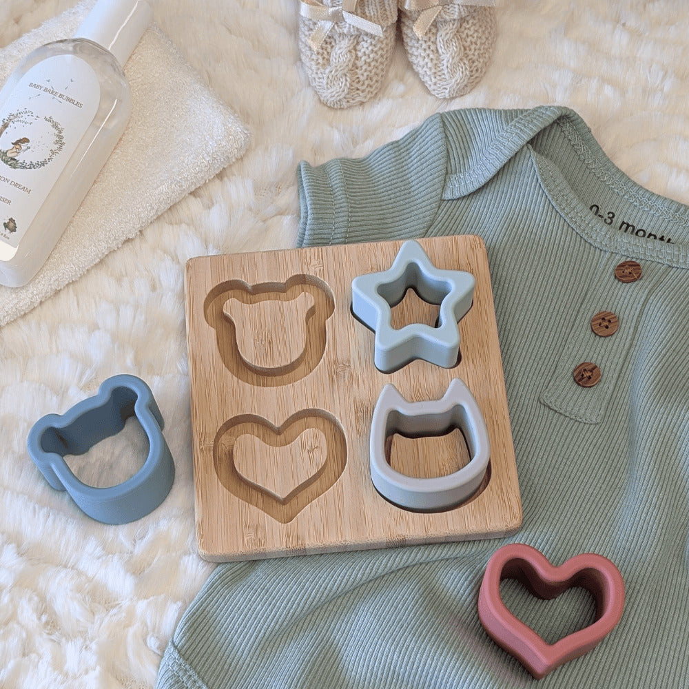 Wooden toy with shape molds for a teething baby.