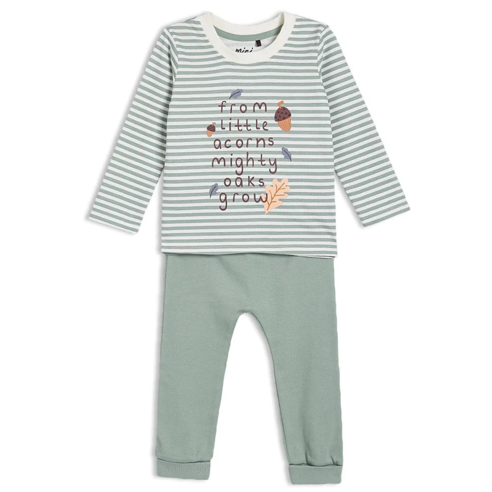 Children's outfit with striped shirt and green pants on a white background