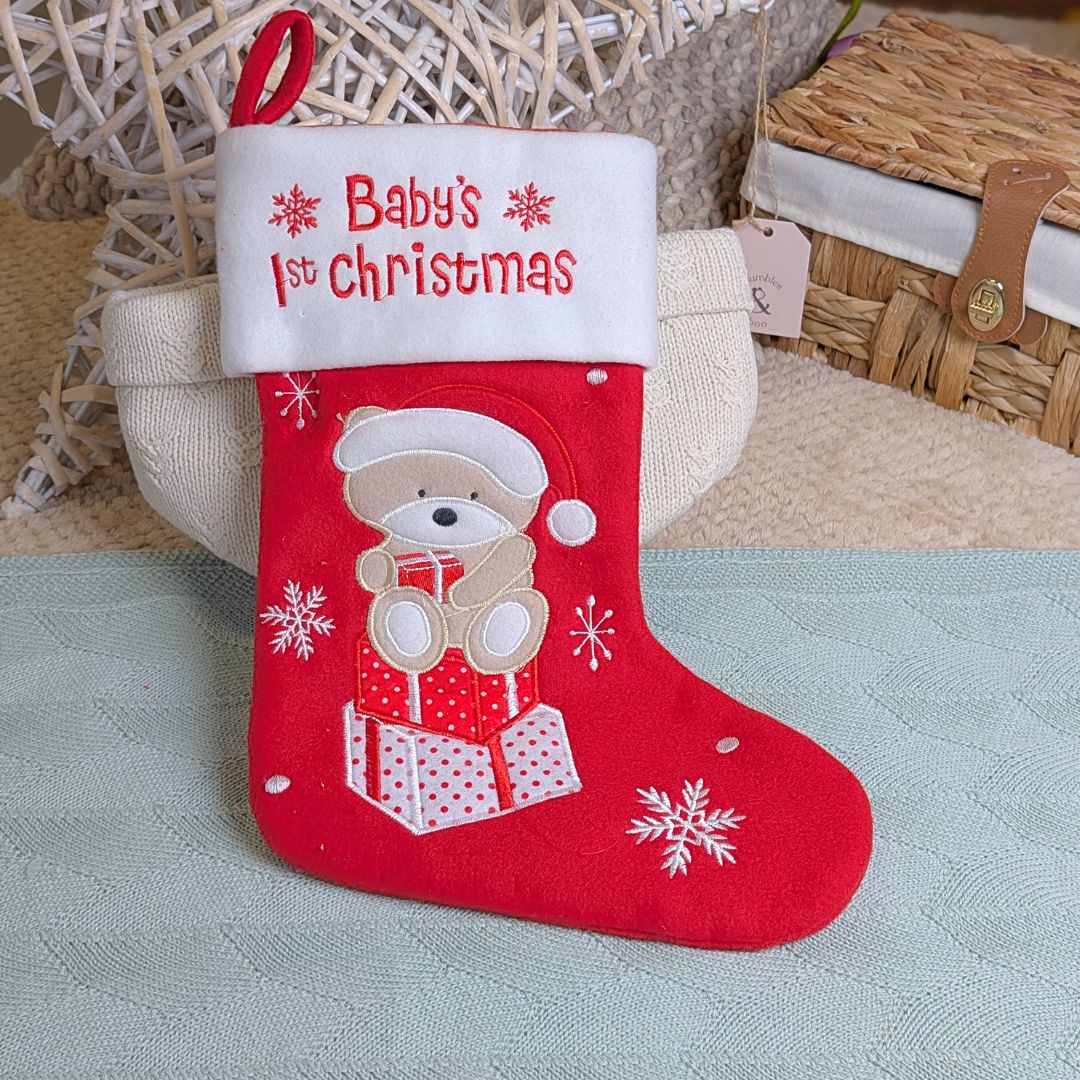 baby's first christmas stocking in red with a teddy bear theme.
