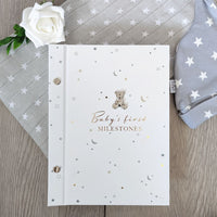 Baby's first milestones white photo album.