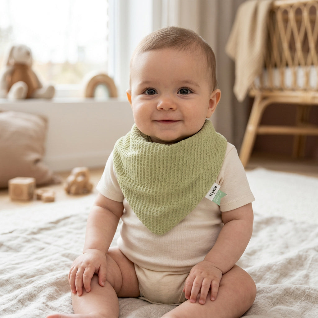 Cocoon Lemongrass green bandana bib with a textured surface and pointed front.