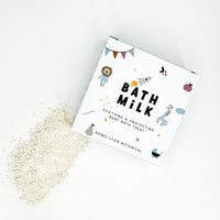 Banks-Lyon baby bath milk box beside scattered bath powder