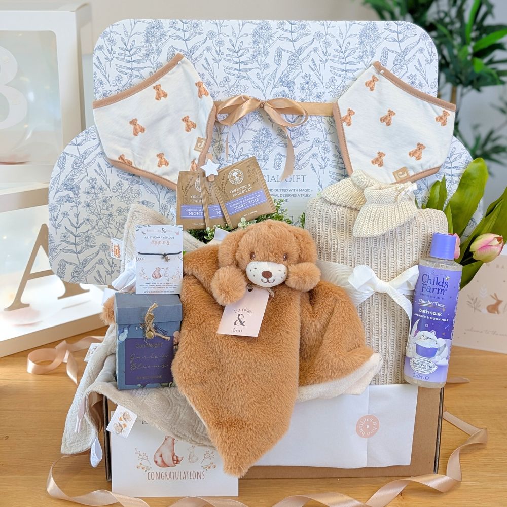 Mum to be gifts hamper with skincare and baby blanket, beautifully presented.