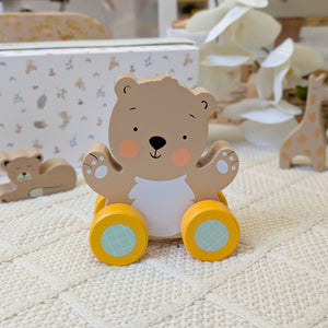 Wooden push along bear toy for a baby.