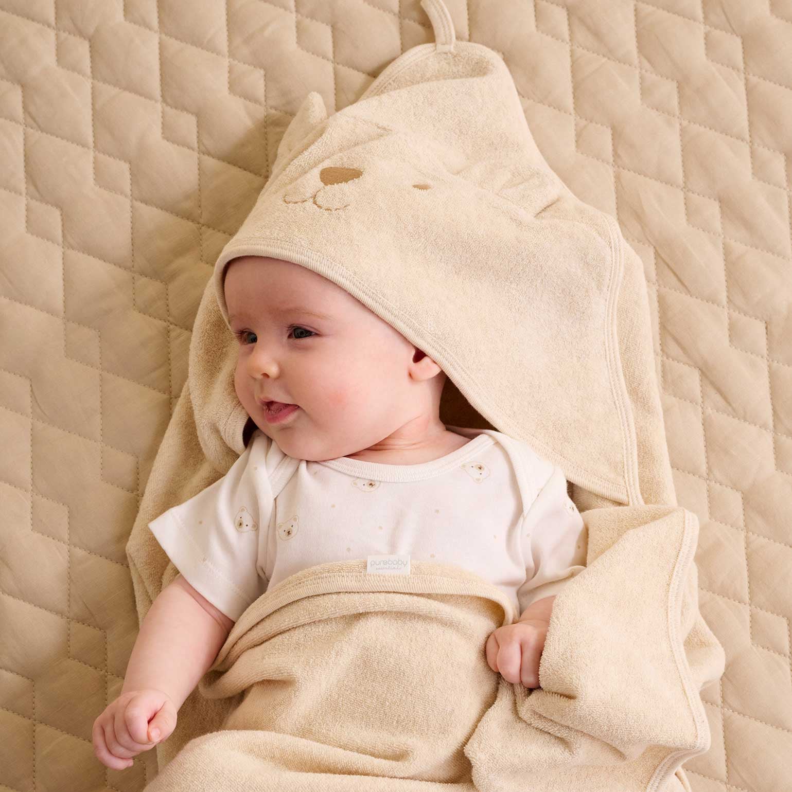 Beige organic hooded towel with bear face embroidery and 3D ears.