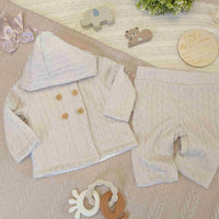Beige baby knit clothing set with trousers and matching cardigan with buttons.