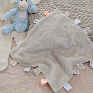 Beige textured taggie comforter with ribbons