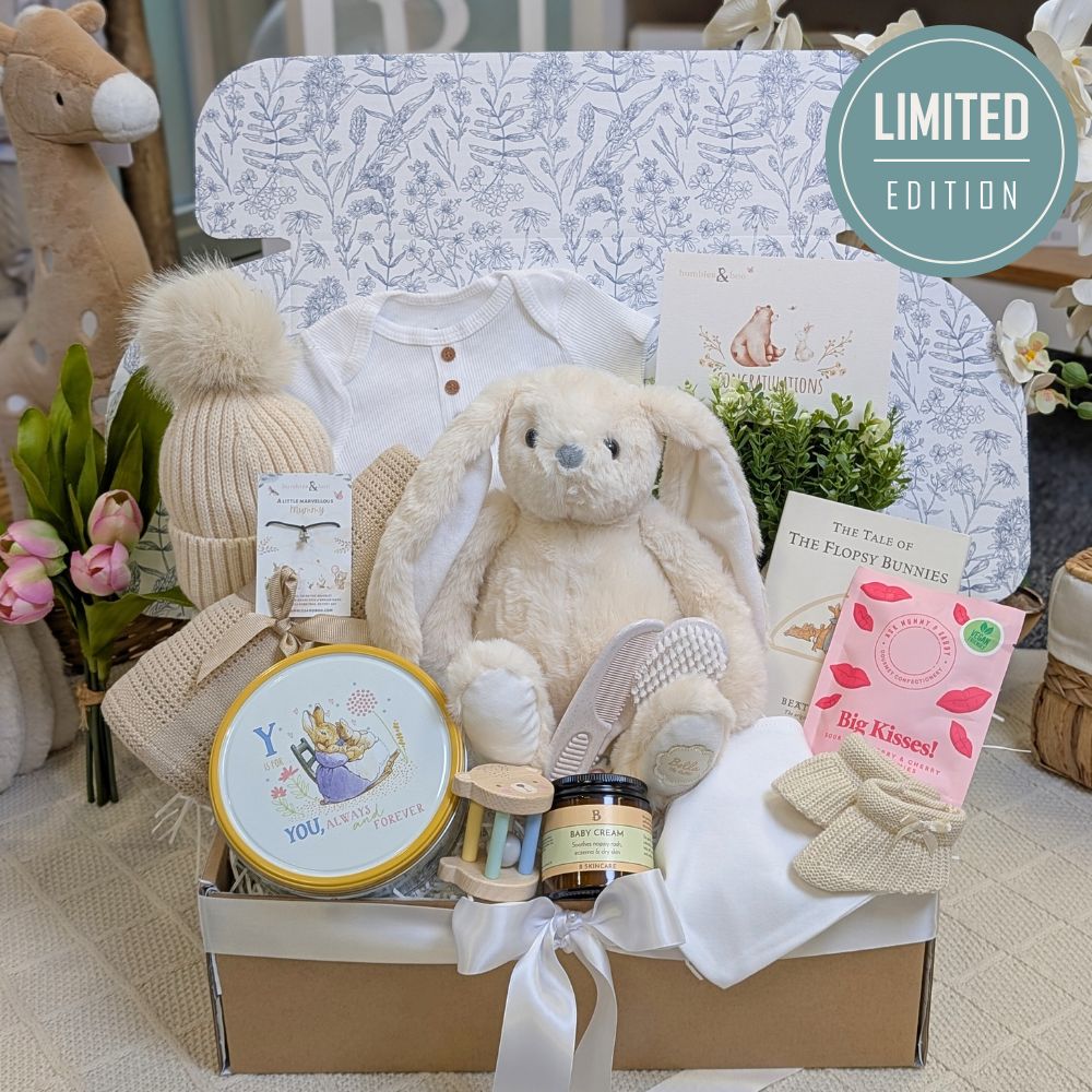 Baby gifts box hamper with toys, clothes, and products in a gifts box.