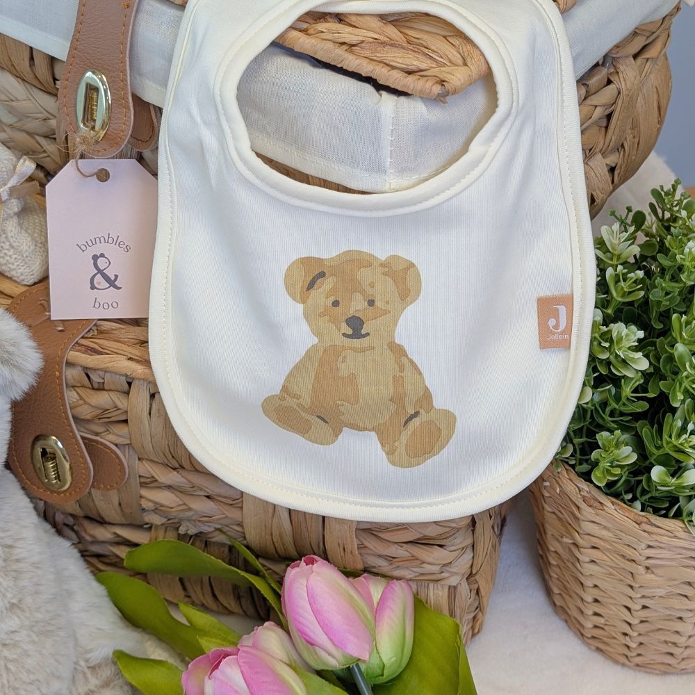 white bib with a cute brown bear on the front