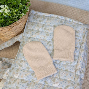 Pair of knit beige cotton mittens in biscuit colour.