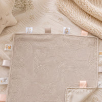 Safari animal embossed neutral biscuit coloured taggie