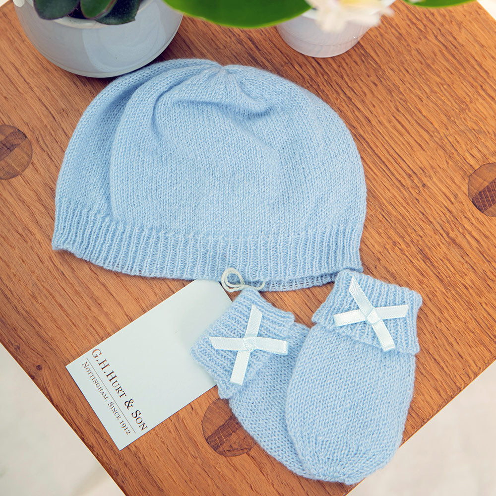 Blue ribbed-edge cashmere newborn hat beside matching mittens; this listing includes the hat only