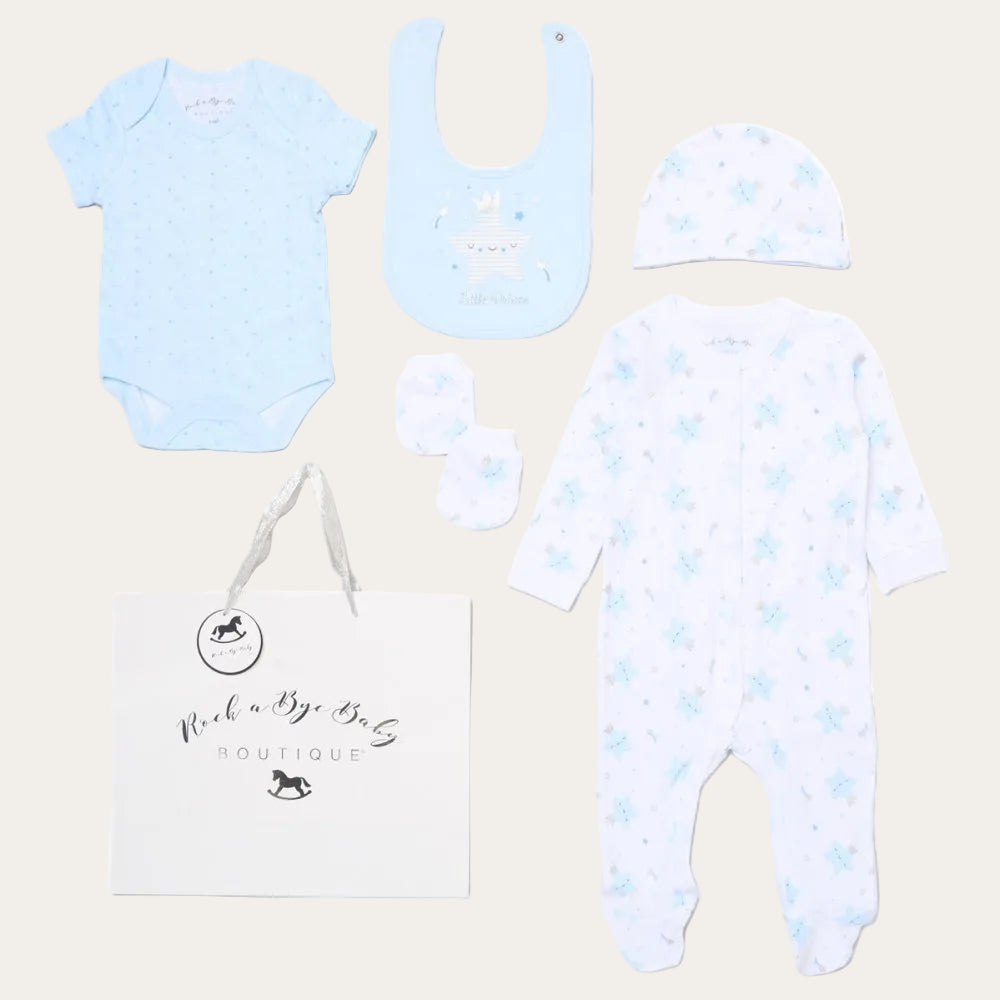 Baby clothing set with onesie, bib, hat, and romper on a white background with little prince and a star