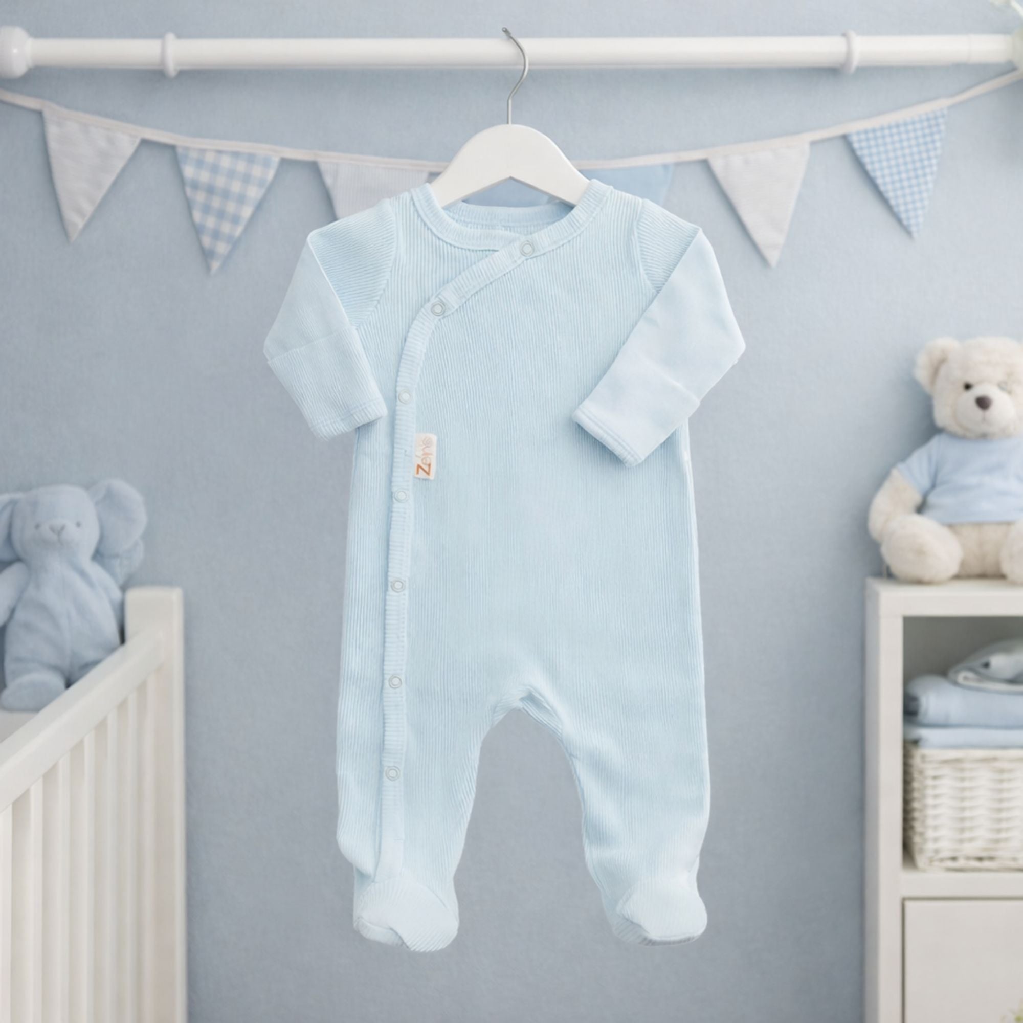 A blue ribbed baby sleepsuit with poppers in eco friendly cotton.