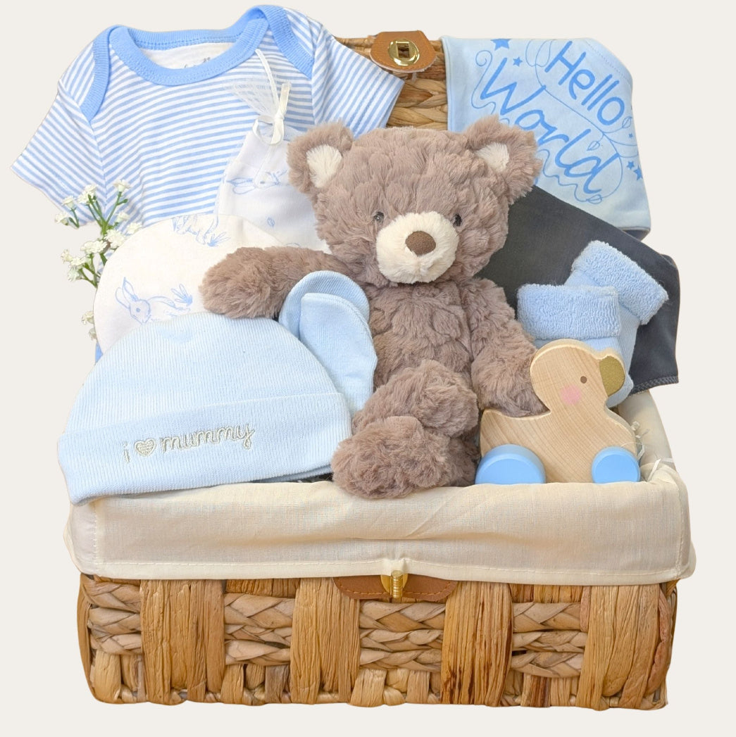 Blue Sky Snuggles baby boy blue gifts hamper with teddy, blanket, toy and newborn essentials. Bumbles & Boo.