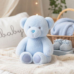 Small sky blue teddy bear soft toy in seated position with plush texture, 20cm size suitable for babies and nursery display