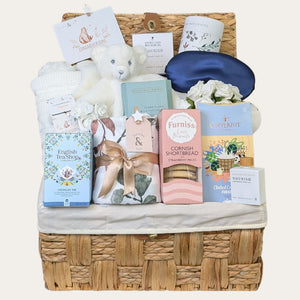 Large mum to be gifts presented in a hamper basket with white teddy and sweet treats for mum to be from Bumbles and Boo. 