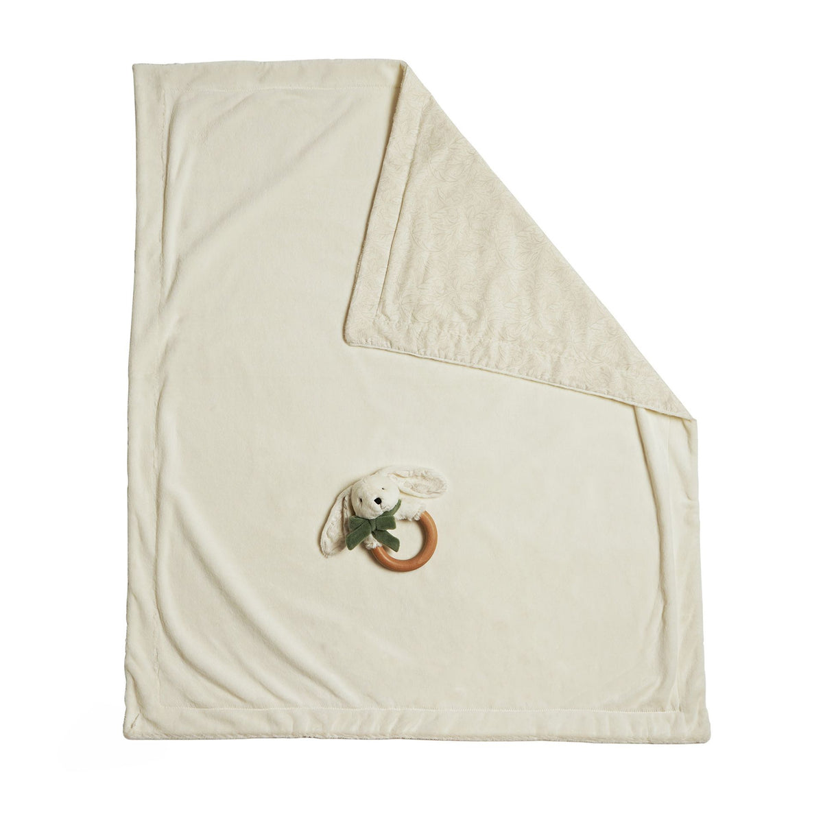 Full cream baby blanket with a folded patterned corner and bunny teether shown against white.