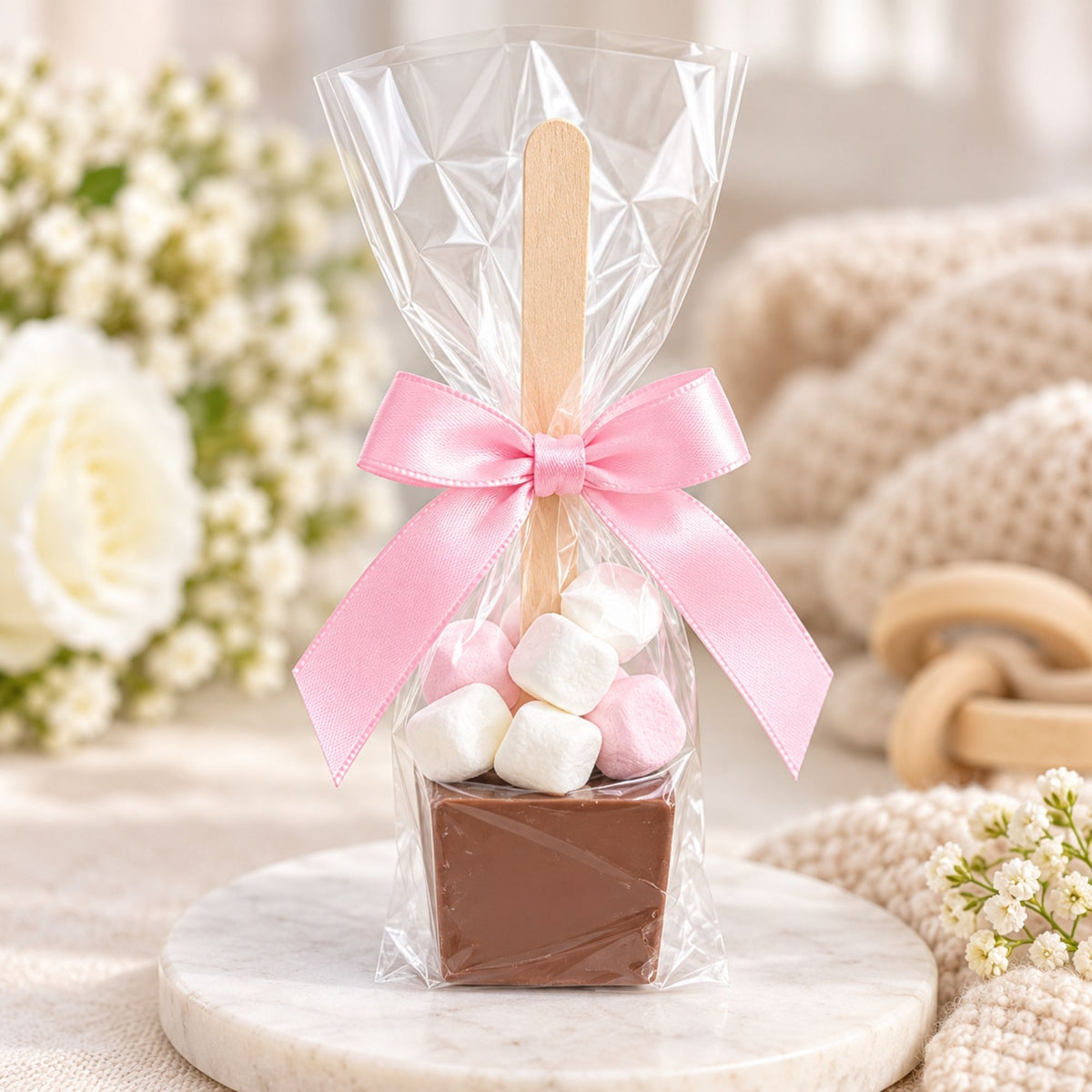 Marshmallow and chocolate treat in a clear wrapper with a pink bow.