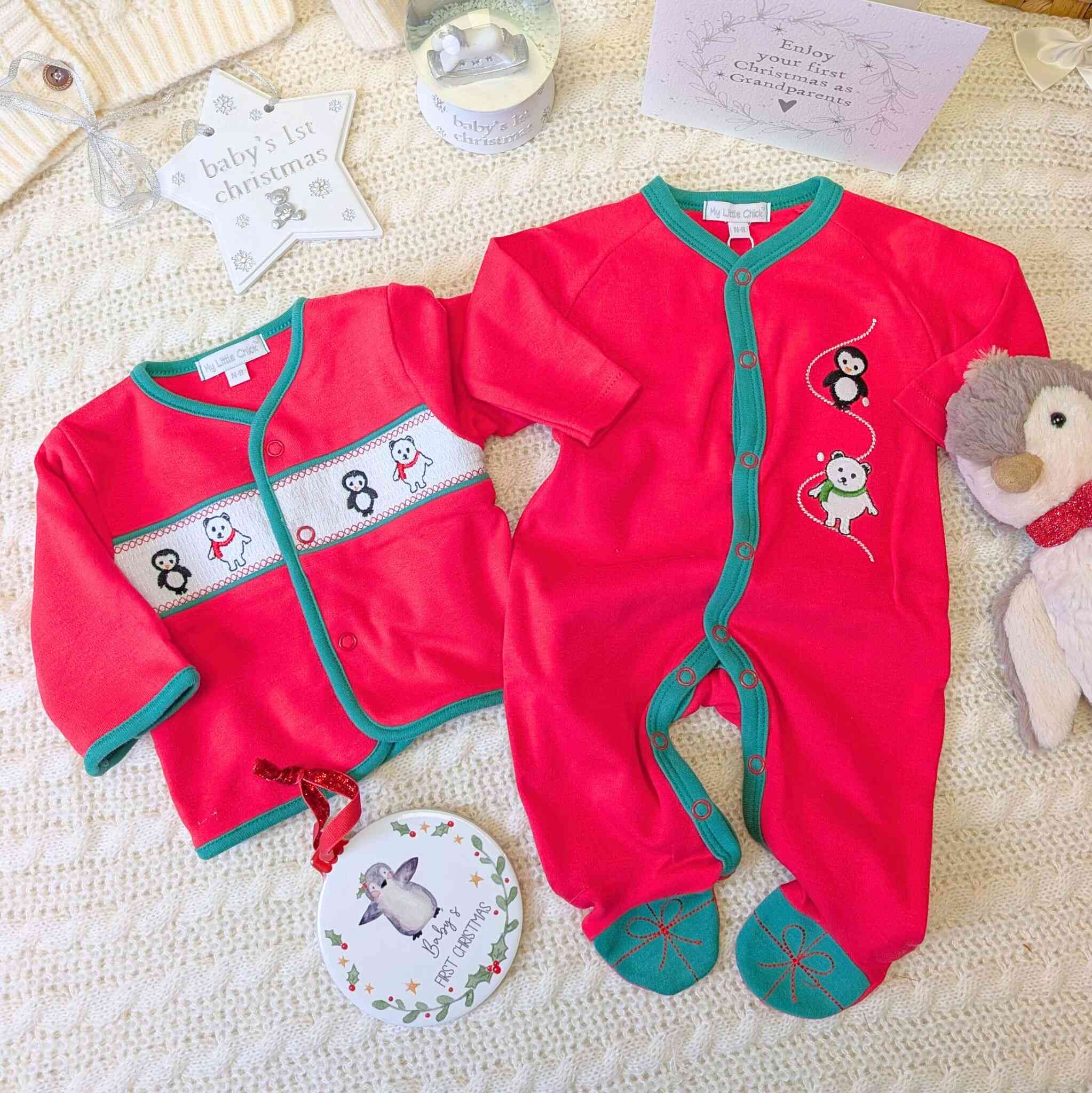 Red Christmas baby onsie with matching red cardigan and penguin.