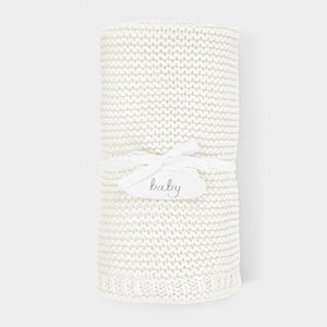 Close-up of white cotton knitted baby blanket showing the soft woven knit and gentle cotton finish.
