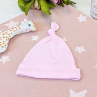 Pink baby hat with a knot.