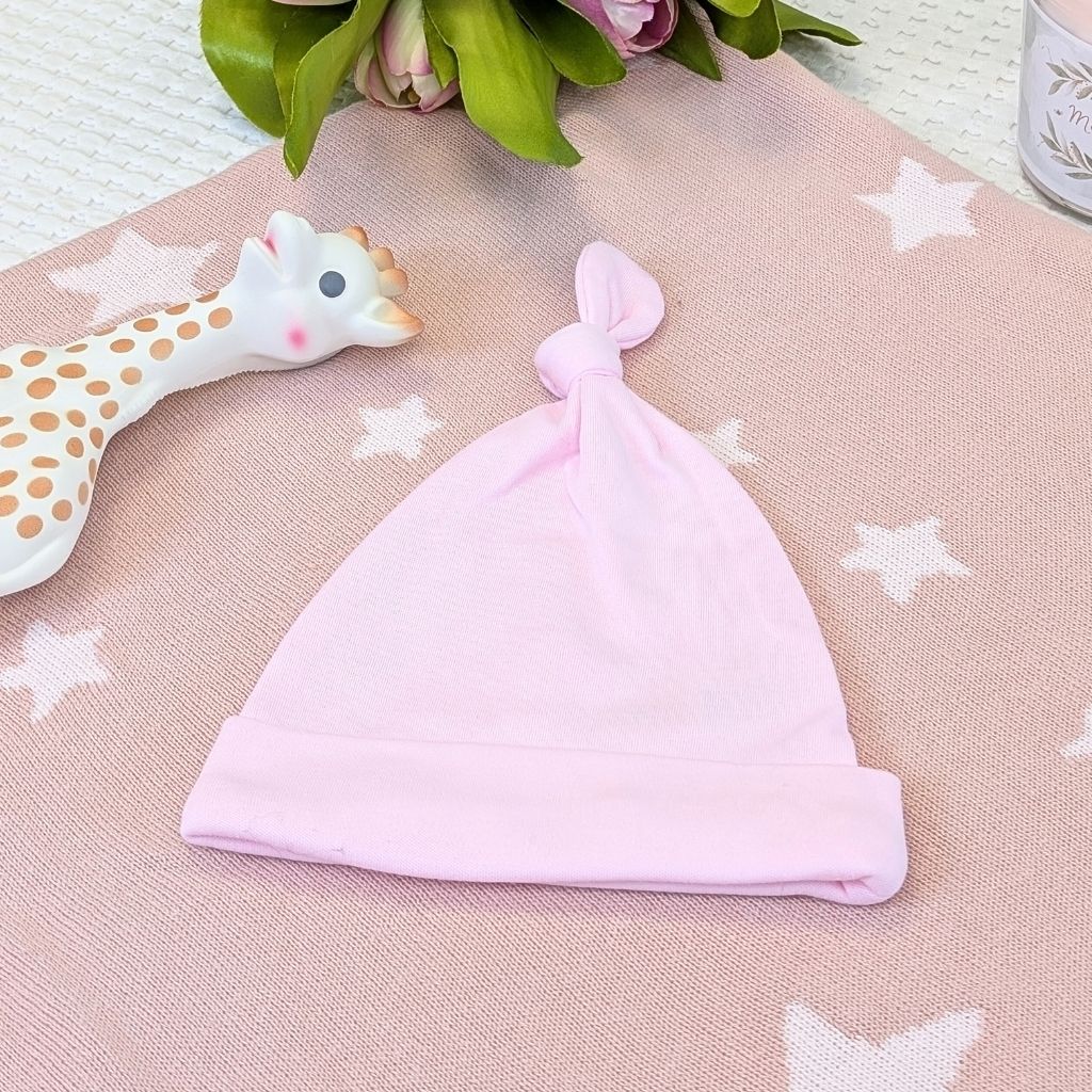 Pink baby hat with a knot.