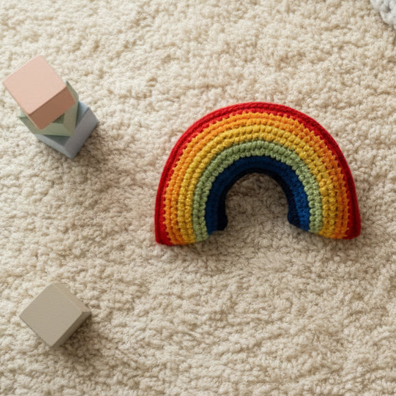 A soft cotton hand crotchet rainbow soft toy